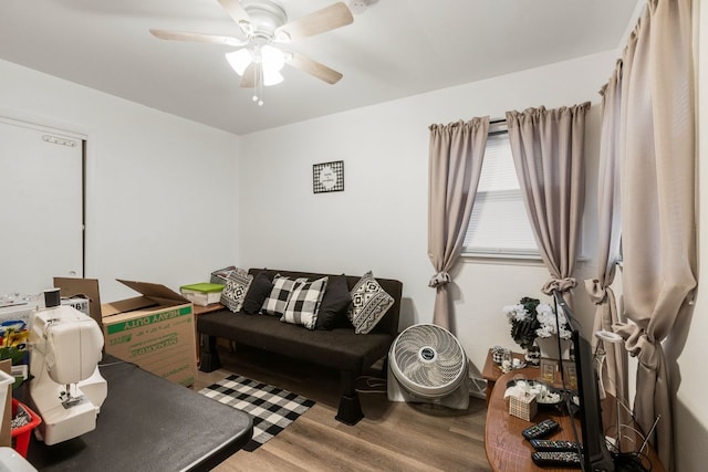 living room with wood-type flooring and ceiling fan