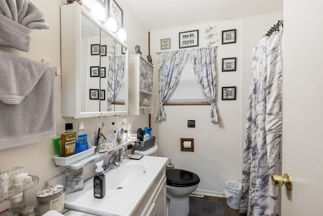 bathroom featuring a shower with shower curtain, tile walls, vanity, and toilet