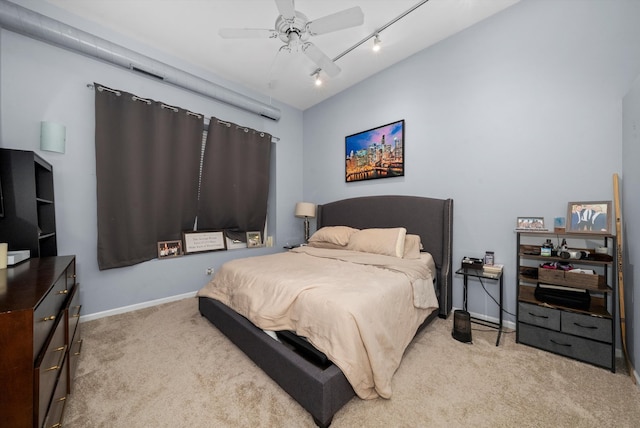 bedroom with track lighting, ceiling fan, and light carpet