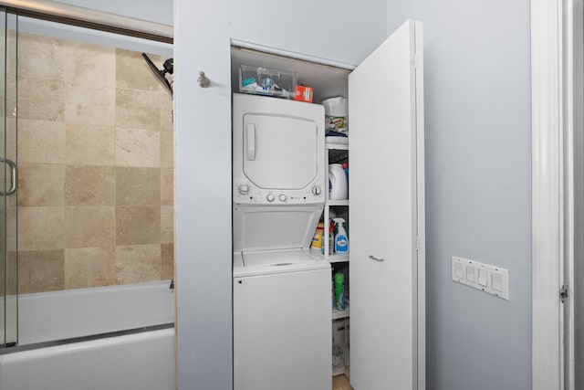 laundry area with stacked washing maching and dryer