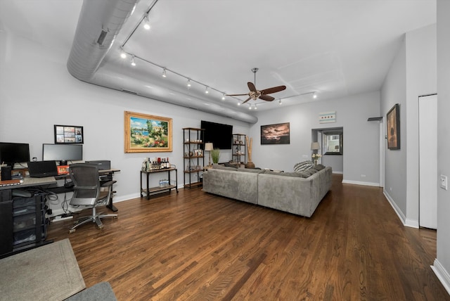 living room featuring rail lighting, ceiling fan, and dark hardwood / wood-style flooring