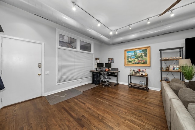 entryway with dark wood-type flooring and track lighting