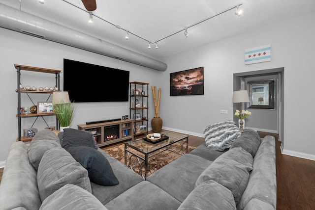 living room with track lighting, dark hardwood / wood-style flooring, and ceiling fan