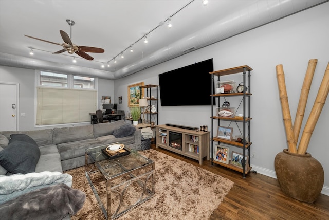 living room featuring ceiling fan, dark hardwood / wood-style floors, and track lighting