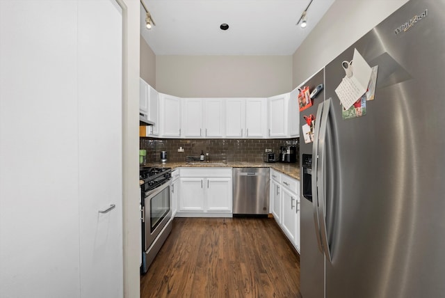 kitchen with light stone countertops, dark wood-type flooring, stainless steel appliances, decorative backsplash, and white cabinets