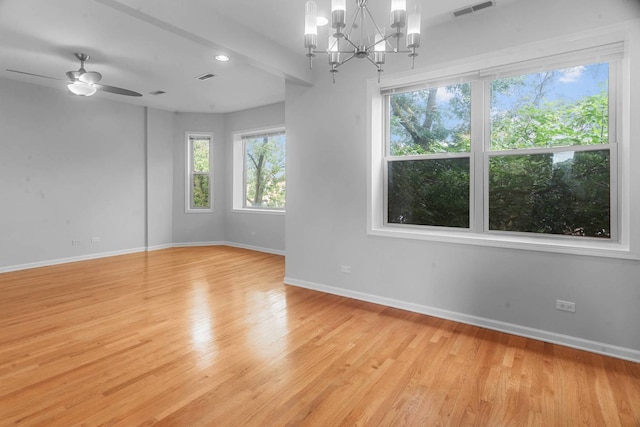 spare room featuring light hardwood / wood-style flooring and ceiling fan with notable chandelier