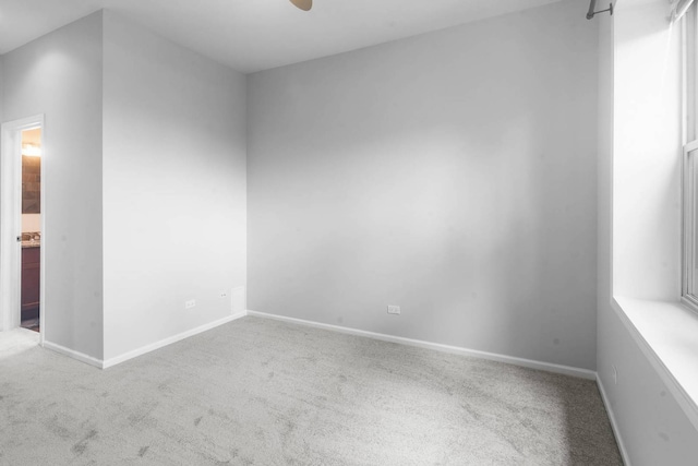 empty room with ceiling fan and carpet