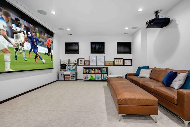 cinema room featuring light colored carpet