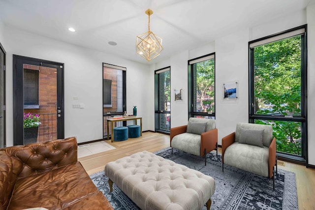 living room featuring an inviting chandelier and light hardwood / wood-style flooring