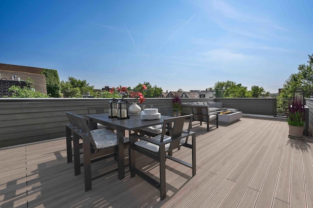 wooden deck with an outdoor fire pit