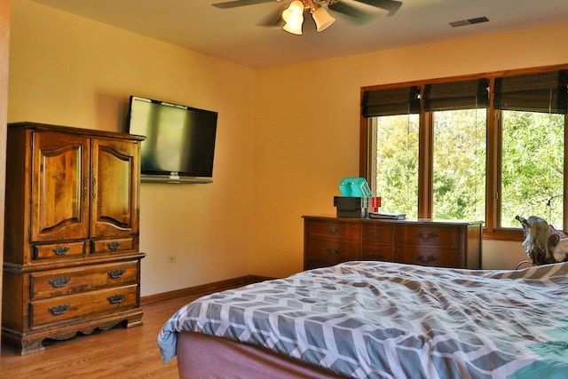 bedroom with ceiling fan and light wood-type flooring