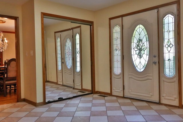 foyer entrance featuring a notable chandelier