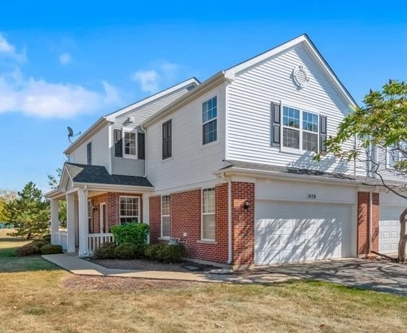 view of front of home with a garage and a front lawn