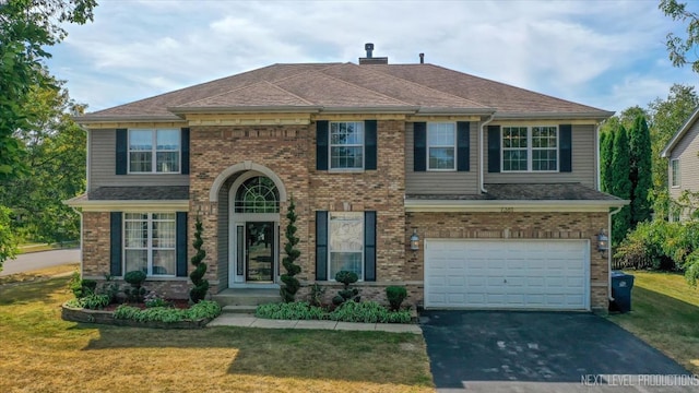 view of front facade with a garage and a front yard