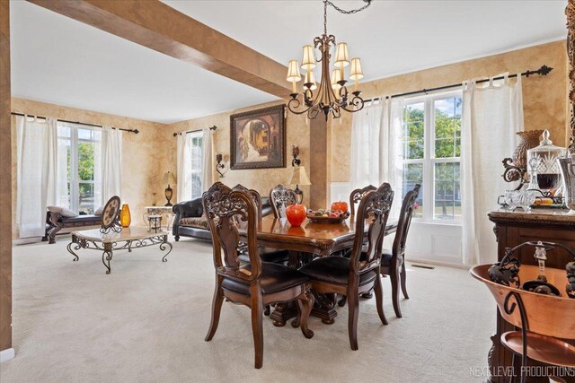 dining room featuring an inviting chandelier and light colored carpet