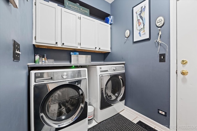 washroom with cabinets, washing machine and dryer, and tile patterned floors