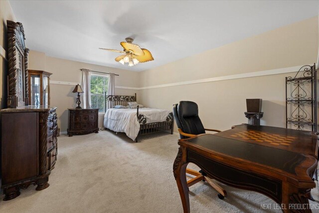 bedroom featuring light colored carpet and ceiling fan