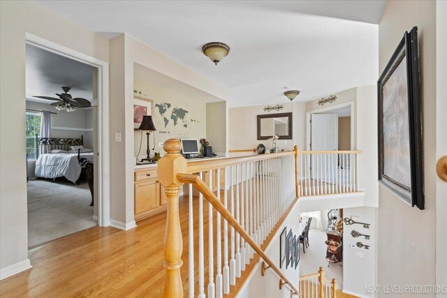 hallway with light hardwood / wood-style floors