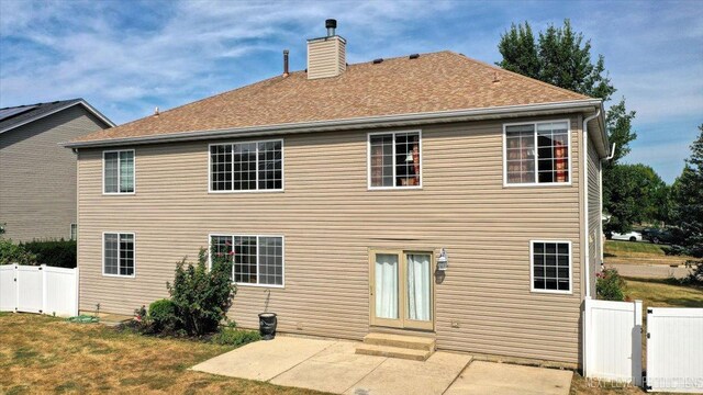 back of house featuring a yard and a patio