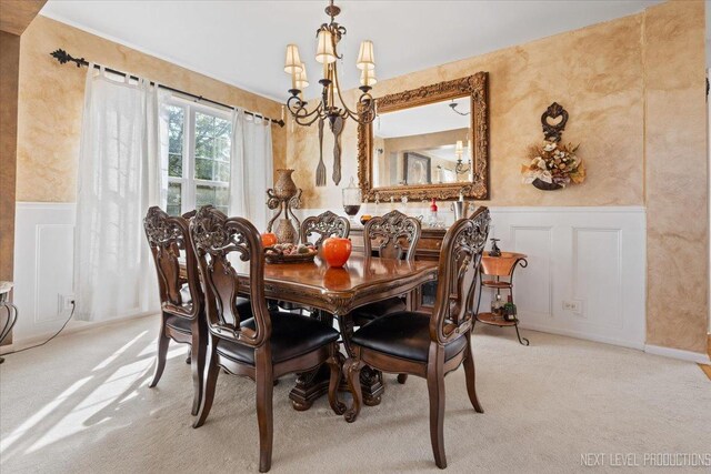 carpeted dining area featuring a chandelier