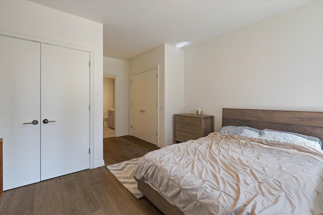 bedroom with a closet and dark hardwood / wood-style floors