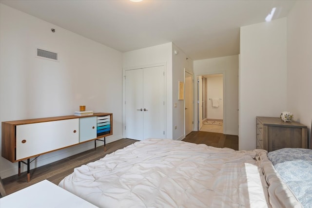 bedroom featuring dark hardwood / wood-style floors and a closet