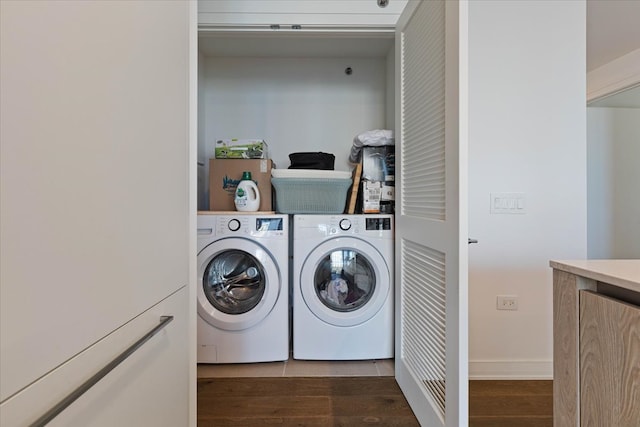 laundry area featuring dark wood-type flooring and washing machine and clothes dryer