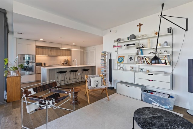 living room with wood-type flooring and sink