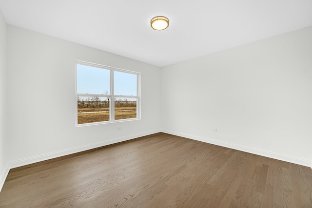 spare room with wood-type flooring