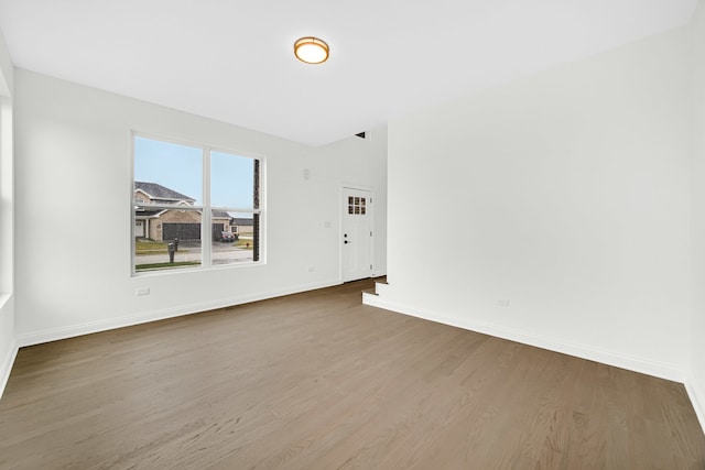 empty room with hardwood / wood-style flooring