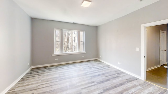 spare room featuring light hardwood / wood-style flooring