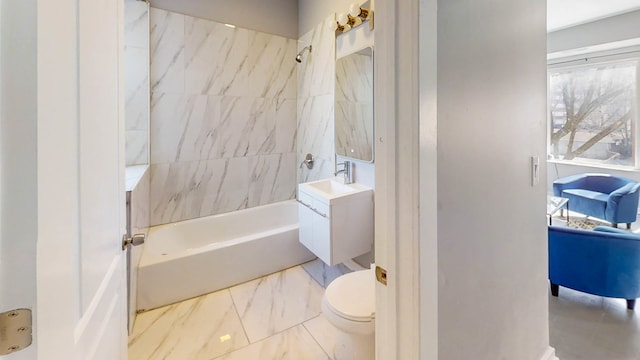 full bathroom with toilet, tiled shower / bath combo, and vanity