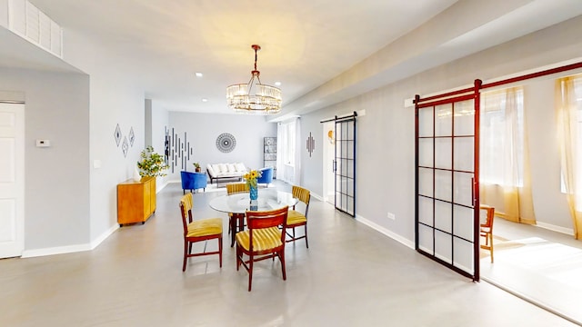 dining space featuring concrete flooring and a notable chandelier