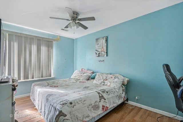 bedroom with ceiling fan and hardwood / wood-style floors