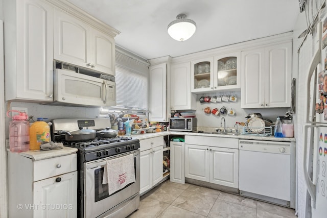 kitchen featuring stainless steel appliances, white cabinets, and sink