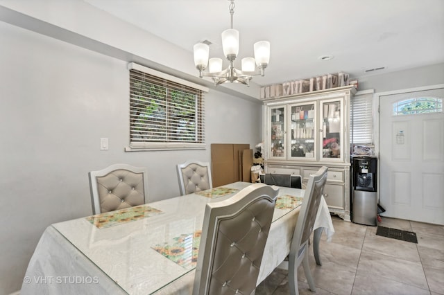 tiled dining space with a notable chandelier