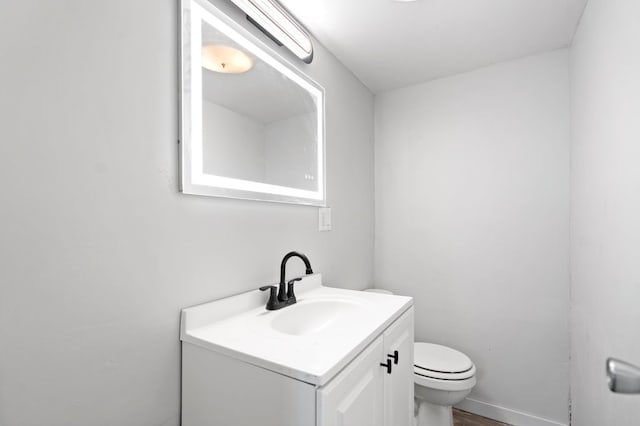 bathroom featuring toilet and vanity