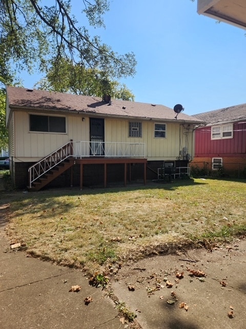 rear view of property featuring a yard