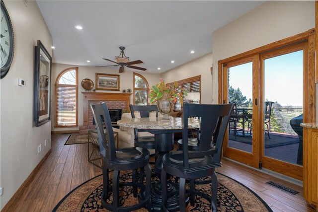 living area featuring high vaulted ceiling, a multi sided fireplace, and ornate columns