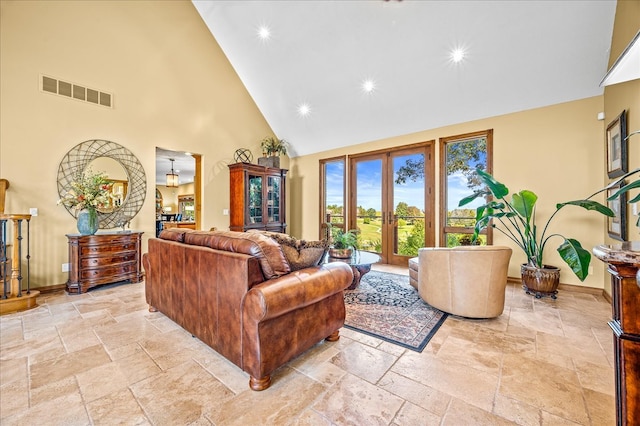 living room featuring high vaulted ceiling and french doors