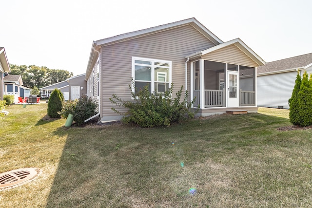 view of front of property featuring a sunroom and a front yard