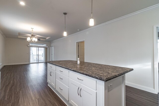 kitchen featuring wall chimney range hood, white cabinets, a kitchen island, and stainless steel appliances