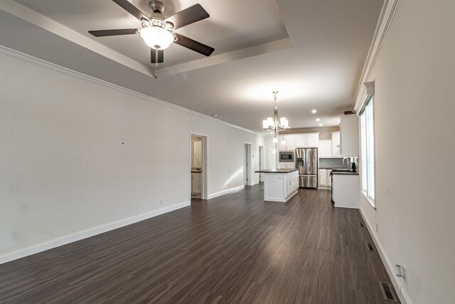 carpeted bedroom with a raised ceiling, ceiling fan, ornamental molding, and multiple windows