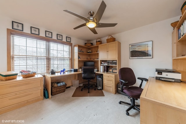 carpeted home office featuring ceiling fan