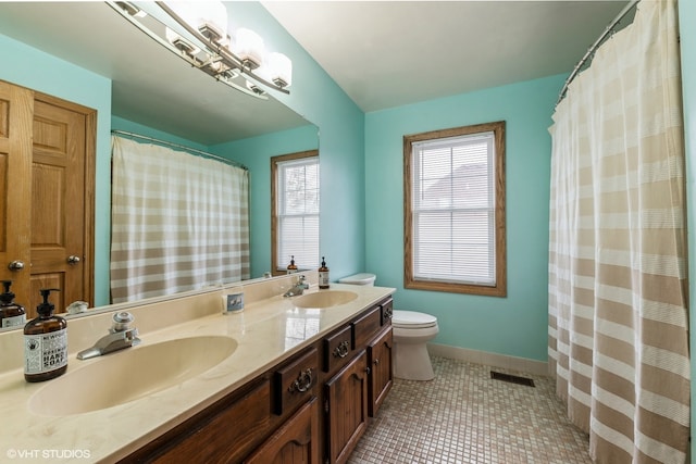 bathroom featuring vanity, toilet, a shower with shower curtain, and tile patterned floors