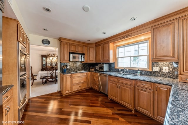 kitchen featuring tasteful backsplash, stainless steel appliances, sink, and dark hardwood / wood-style floors