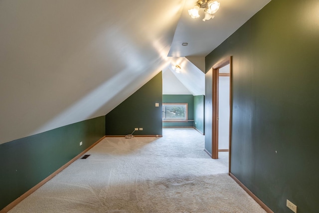 bonus room with lofted ceiling and carpet floors