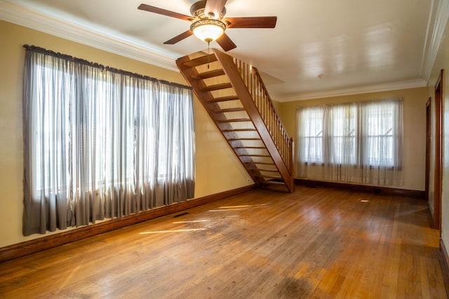 unfurnished living room with ceiling fan, ornamental molding, and hardwood / wood-style floors