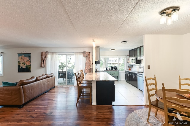 interior space featuring a textured ceiling, sink, and wood-type flooring