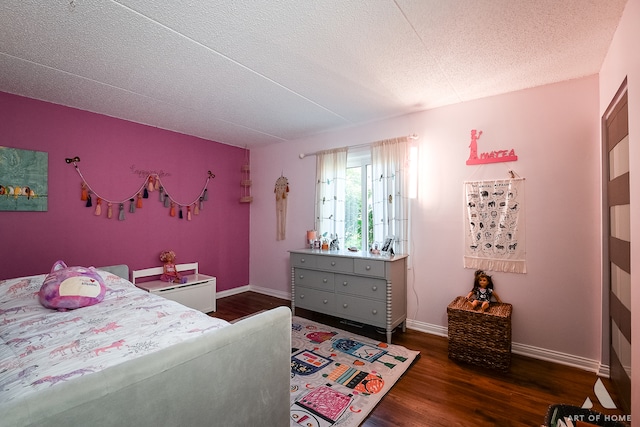 bedroom with dark hardwood / wood-style flooring and a textured ceiling